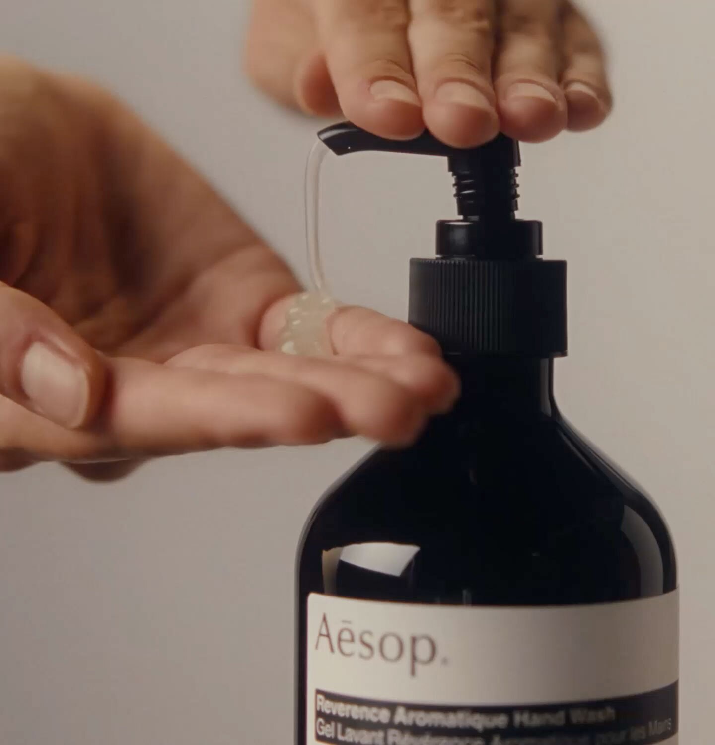 Hands dispensing reverence aromatique hand wash