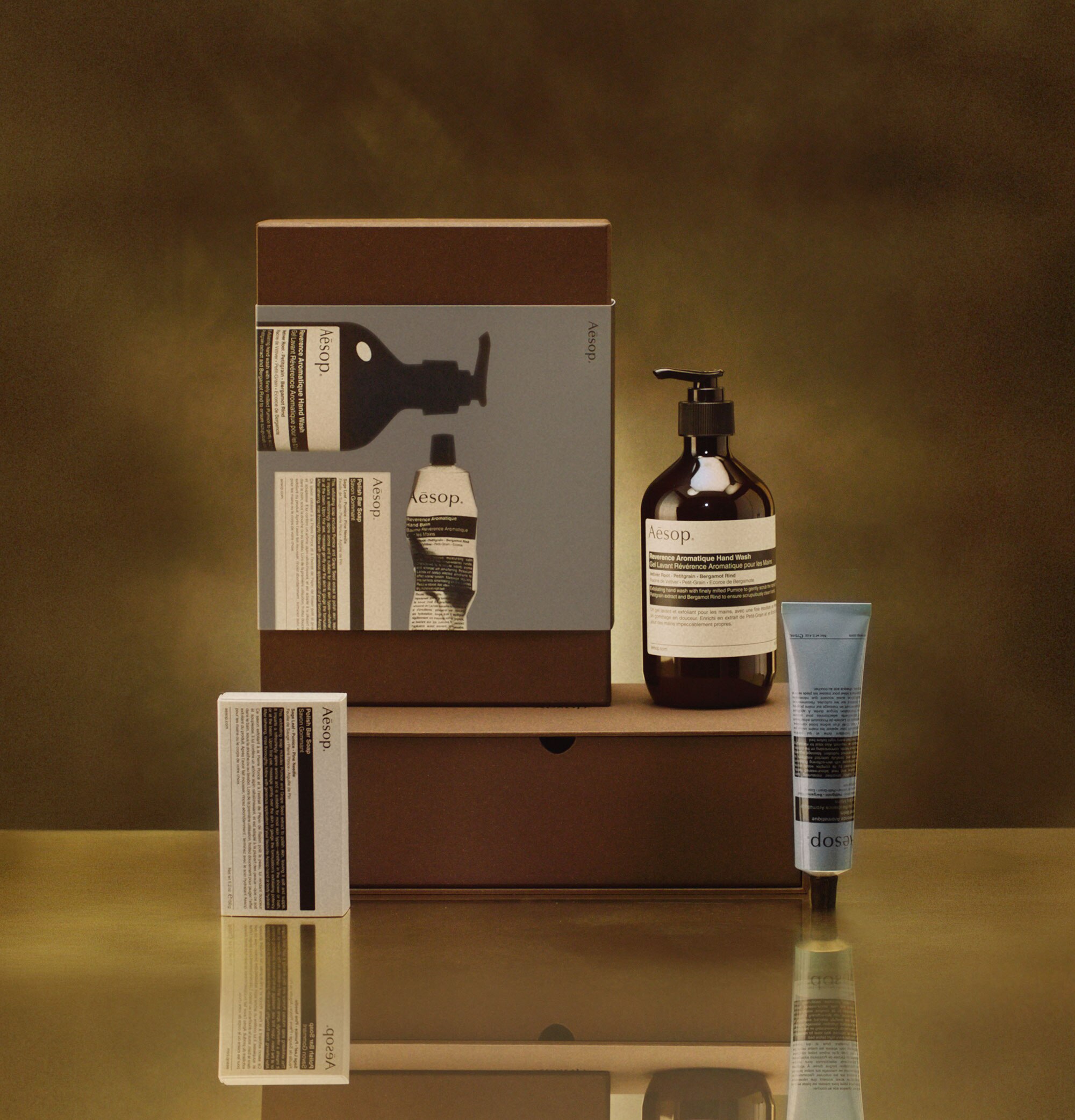 Aesop Too Many Cooks in the Kitchen festive gift kit on a brass countertop.