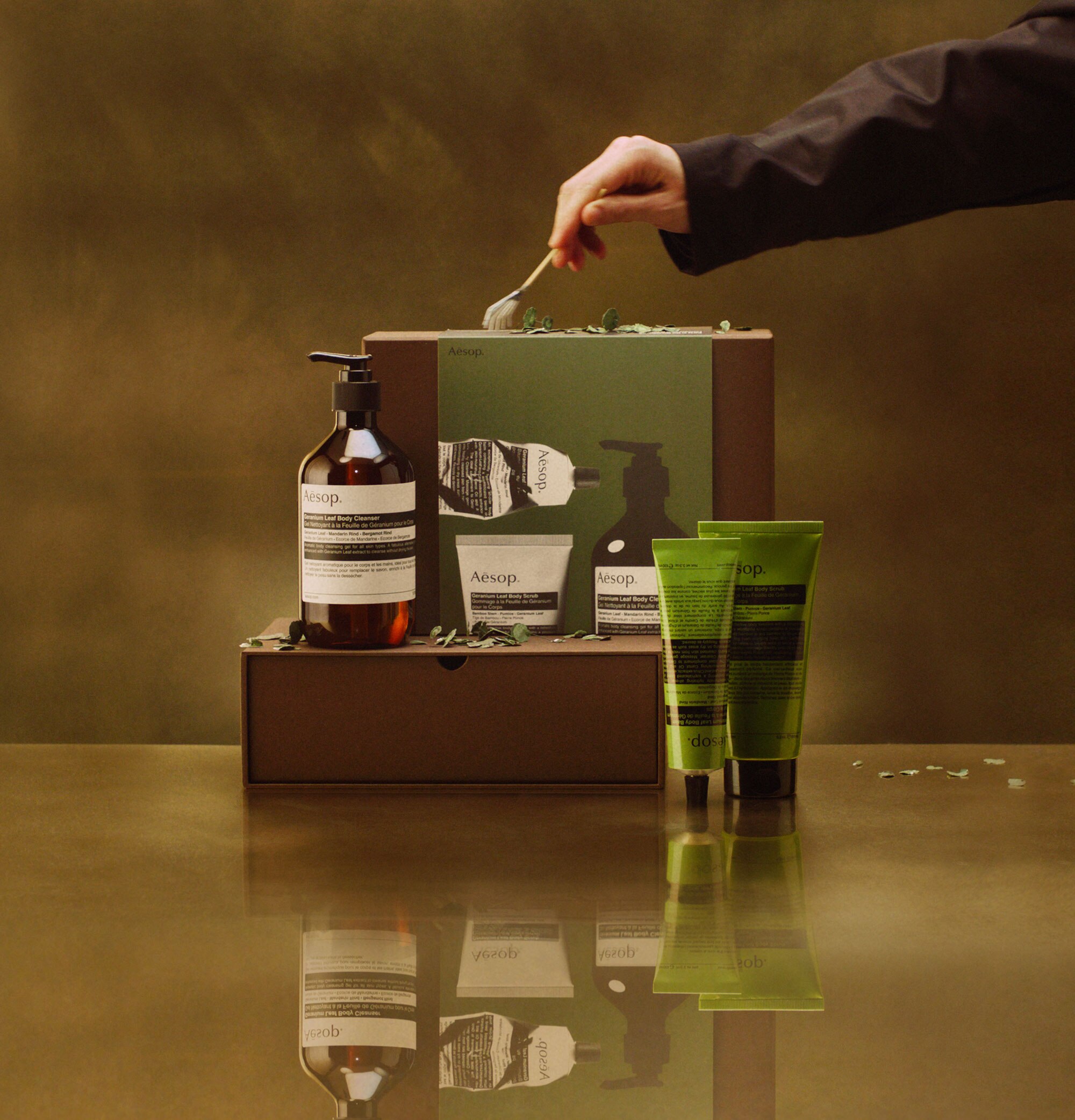 Aesop Party in the Greenhouse festive gift kit on a brass countertop.