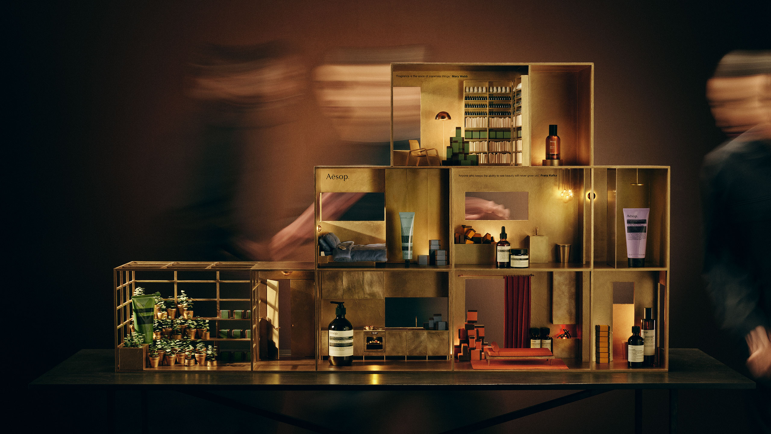 Festive miniature brass dolls house featuring a variety of Aesop products in every room.