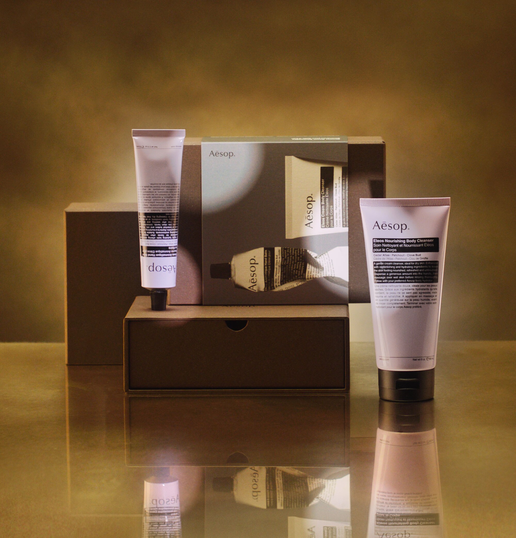 Aesop Shower Room Serenades festive gift kit on a brass countertop.